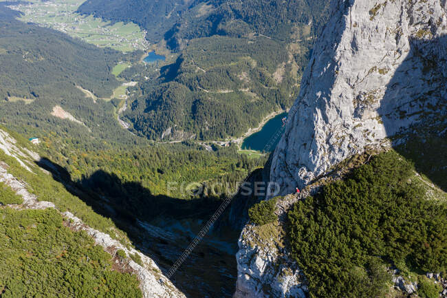 Man watching a woman climbing up a via ferrata, Gosau, Gmunden, Upper Austria, Austria — Fotografia de Stock