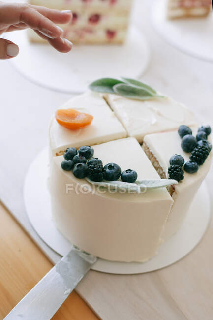 Woman serving a slice of cake — Stock Photo