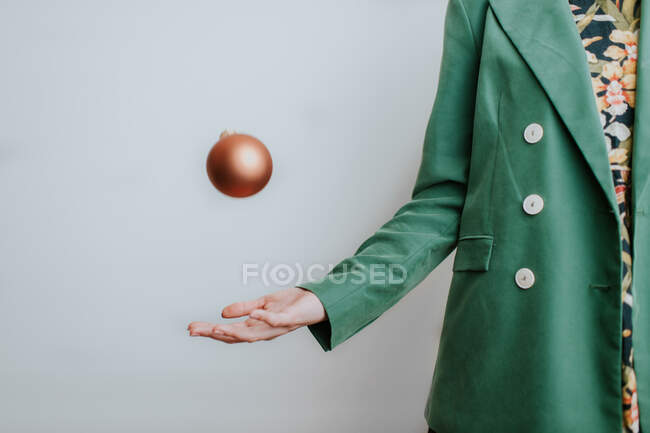 Woman throwing Christmas bauble in air — Stock Photo