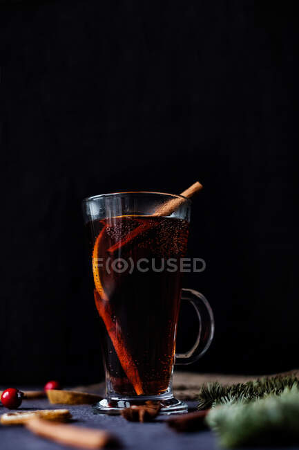 A glass of mulled wine with oranges and spices — Stock Photo