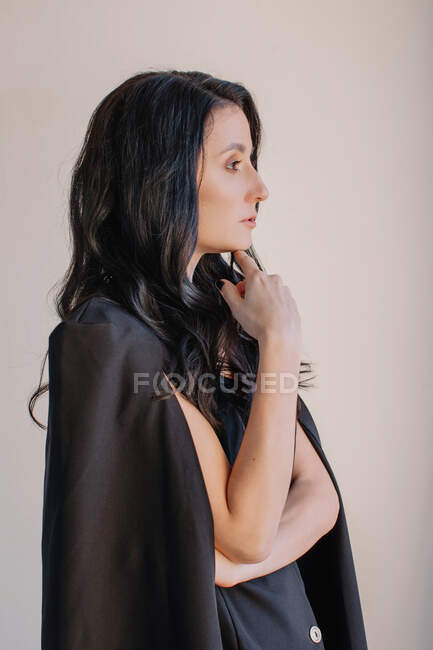 Portrait of thoughtful woman wearing tuxedo dress — Stock Photo