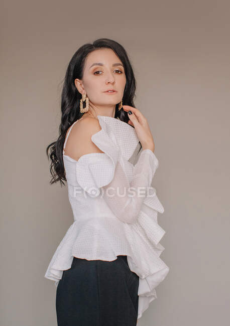 Elegant and stylish woman posing at camera — Stock Photo