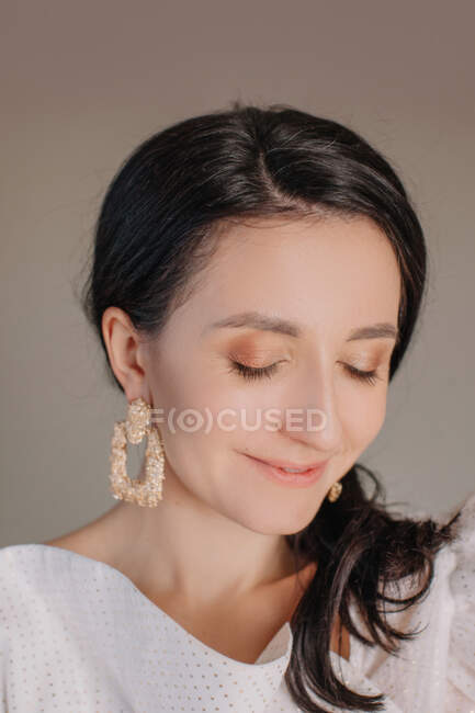 Portrait of smiling woman with beautiful earring — Stock Photo
