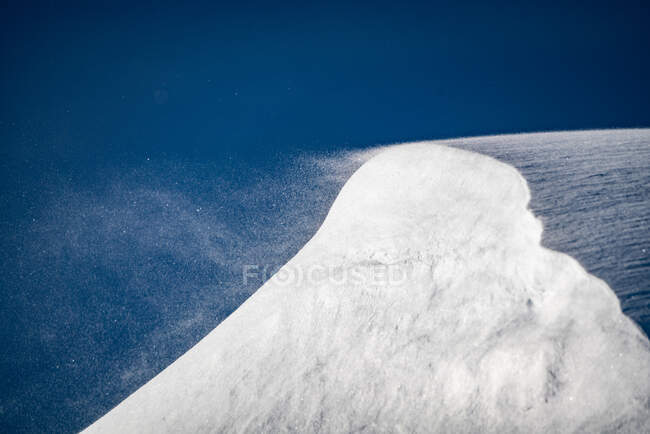 Storm blowing snow off a mountain ridge in the Kootenays near Kaslo, British Columbia, Canada — Stock Photo