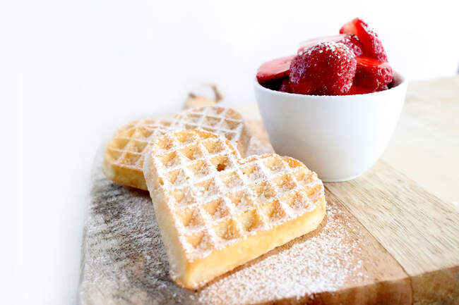 Heart shaped waffles with fresh strawberries and cream — Stock Photo