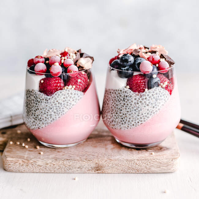 Two Chia and Panna cotta desserts with raspberries, blueberries and redcurrants — Stock Photo