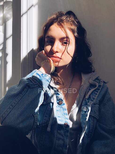 Portrait of teenage girl with sunlight and shadows on face — Stock Photo