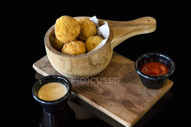 Deep fried mashed potato fritters with dipping sauces — Stock Photo