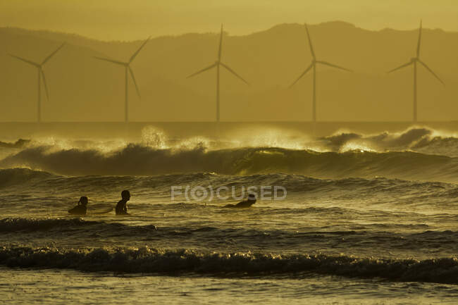 Three surfers in the ocean, Sopelana beach, Bilbao, Spain — Stock Photo