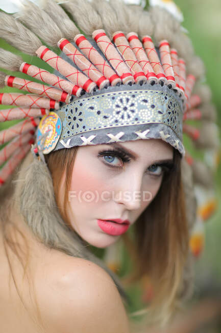 Portrait of a woman wearing a North American Tribal headdress — Stock Photo