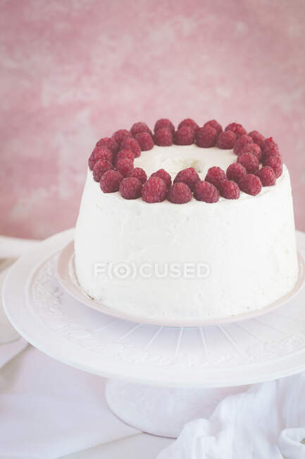 Raspberry cream cake on cake stand, close view — Stock Photo