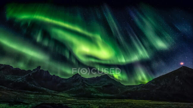 Aurora boreale verde luce sul paesaggio montagnoso — Foto stock
