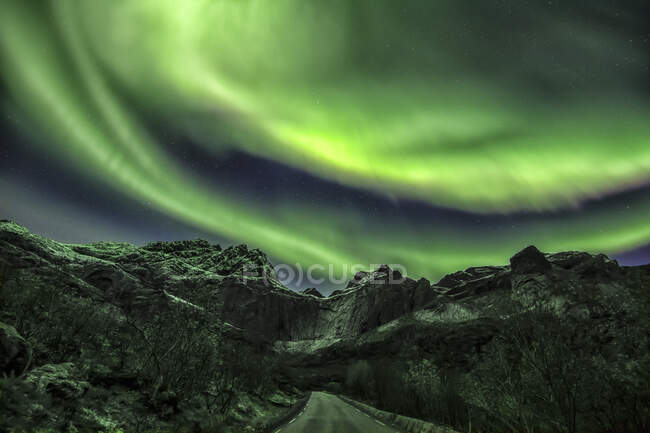 Grünes Polarlicht über bergiger Landschaft — Stockfoto