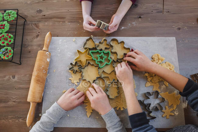Children making Christmas cookies on table, top view — Stock Photo