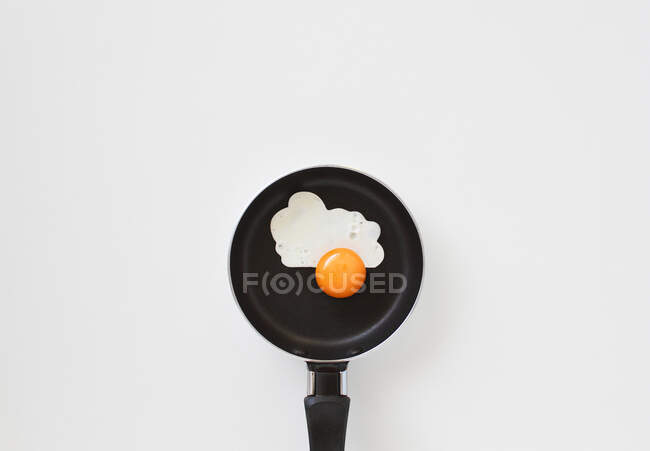 Small pan with fried egg on white background — Stock Photo