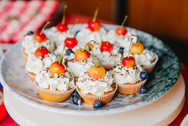 Cherry cupcakes with blueberries — Stock Photo