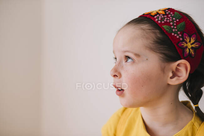 Porträt eines emotionalen kleinen Mädchens auf weißem Wandhintergrund — Stockfoto