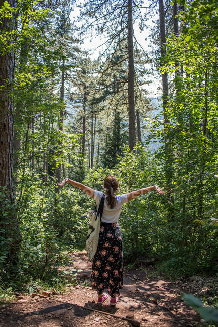 Femme debout dans la forêt les bras tendus, Bosnie-Herzégovine — Photo de stock