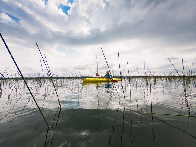 Senior woman kayaking on a lake, United States — Stock Photo