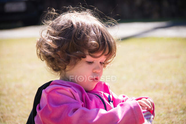 Portrait of a girl in a park playing with her socks — Stock Photo