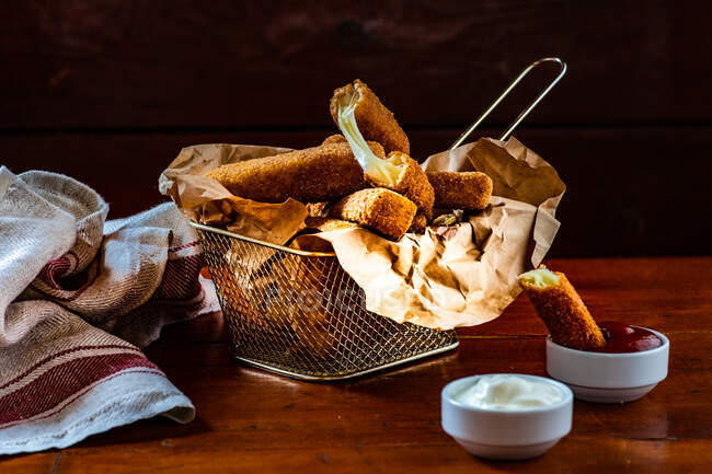 Deep fried cheese sticks with ketchup and mayonnaise — Stock Photo