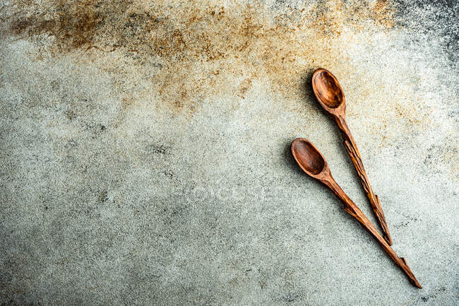 Two wooden spoons on a rustic table — Stock Photo