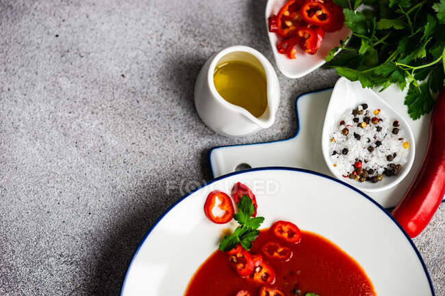 Вид зверху миски томатного супу зі свіжим чилі та петрушкою — стокове фото