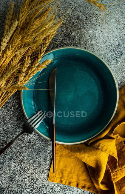 Autumnal place setting with ears of wheat on table, top view — Stock Photo