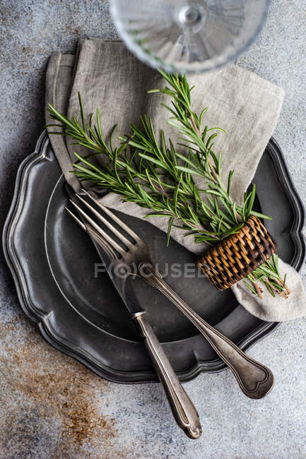 Rustic table setting with fresh rosemary decoration, top view — Stock Photo