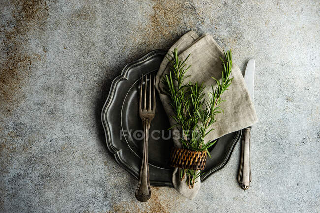 Rustic table setting with fresh rosemary decoration — Stock Photo