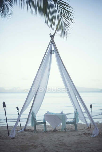 Mesa e cadeiras sob um mandril de tecido romântico na praia, Koh Yao, Phang Nga, Tailândia — Fotografia de Stock