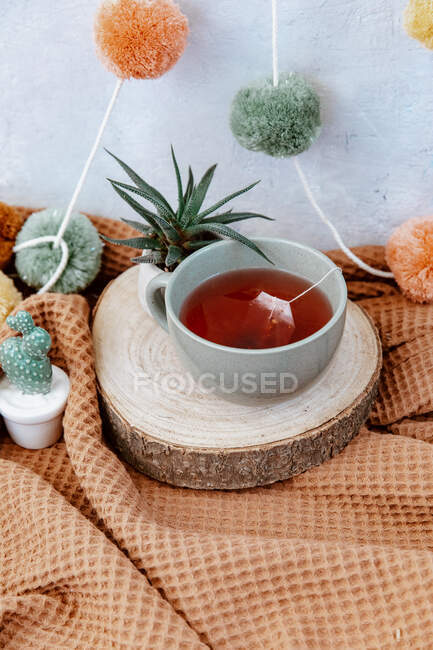 Tea and candles, cup and cookies with a candle on the background. — Stock Photo