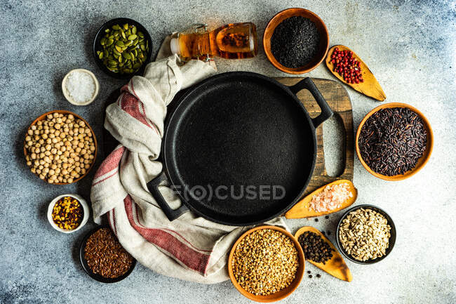 Raw grain and seed variety in a bowl on concrete background — Stock Photo