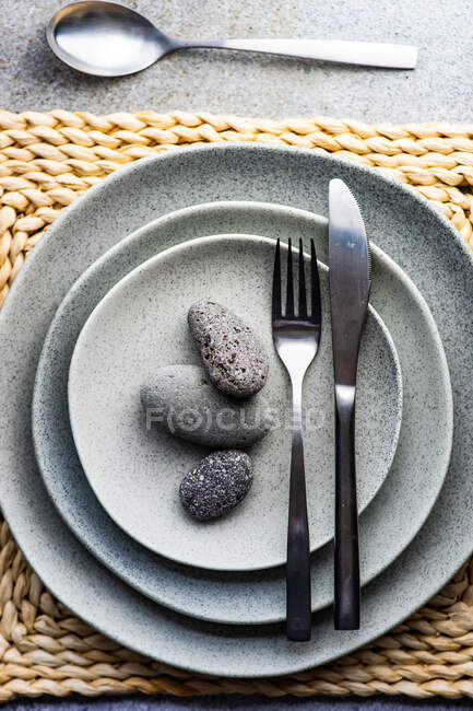 Luogo di impostazione per la festa in spiaggia decorata con pietre di mare sui piatti — Foto stock