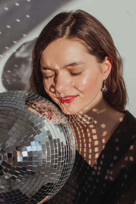 Portrait of a woman holding a glitter ball — Stock Photo
