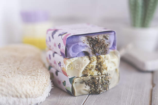 Stack of three bars of natural organic bars of soap on a table — Stock Photo