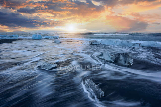 Ice formations on Diamond Beach at sunset, Jokulsarlon, Vatnajokull Glacier National Park, Iceland — Stock Photo