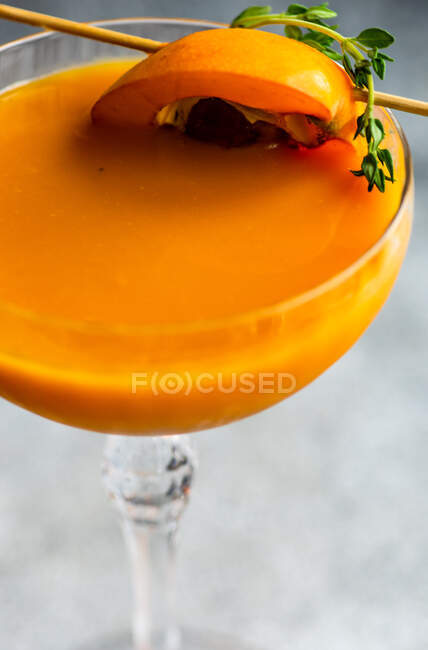 Glass of loquat fruit juice with loquat and thyme on stick — Stock Photo