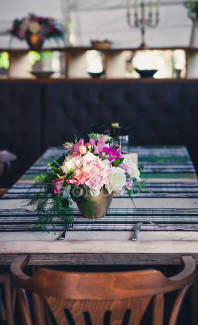 Bunch of flowers on dining room table — Stock Photo