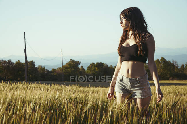 Adolescente debout dans la prairie avec les bras tendus, Espagne — Photo de stock