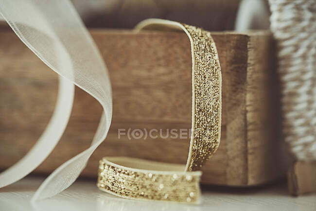 Close-up of ribbons in a wooden box on a table — Stock Photo