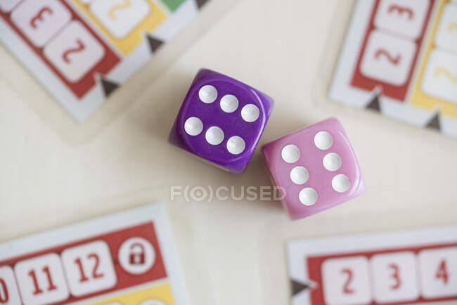 Colorful dice with board game, top view — Stock Photo