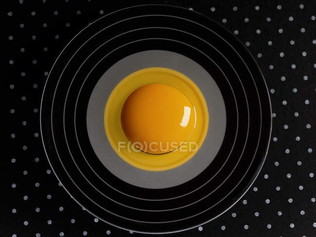 Top view of plate with liquid egg — Stock Photo