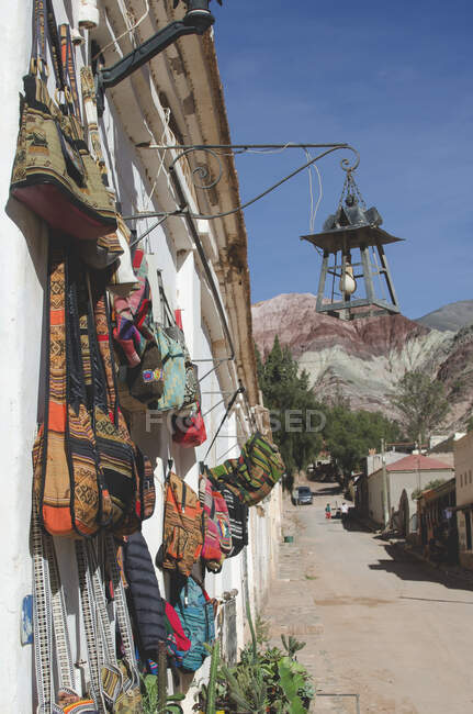 Handmade ethnic bags hanging on building for sale — Stock Photo