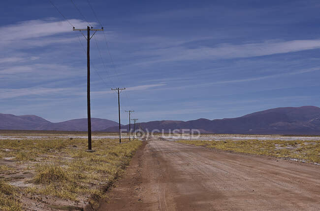 Electricity pylons along a rural road, Jujuy, Argentina — Stock Photo
