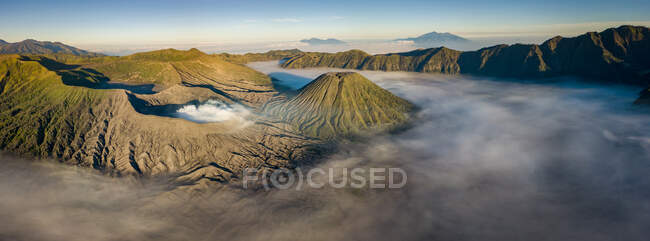 Panoramic shot of beautiful sunrise over the volcano valley — Stock Photo