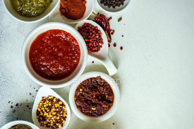 Overhead view of dried chilli, chilli paste and assorted spices — Stock Photo