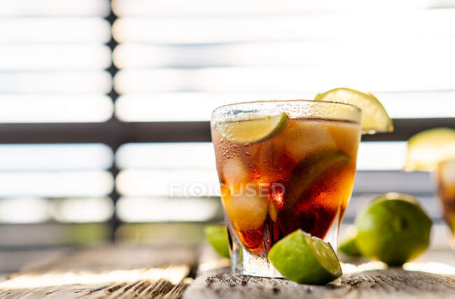 Cuba Libre cocktail with brown rum and lime — Stock Photo