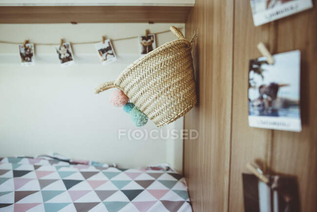 Stylish interior with basket and printed photos — Stock Photo