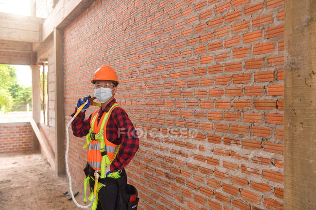 Roofer Construction worker install new roof. Roofing tools. Electric drill used on new roofs with Metal Sheet. — Stock Photo